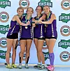 Four athletes in purple uniforms pose holding medals before an OHSAA-branded backdrop.