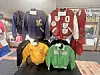 Colorful vintage sports jackets displayed indoors on hangers and mannequins.