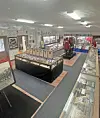 Museum exhibit room with glass display cases, framed items, banners, and informational panels on the walls.