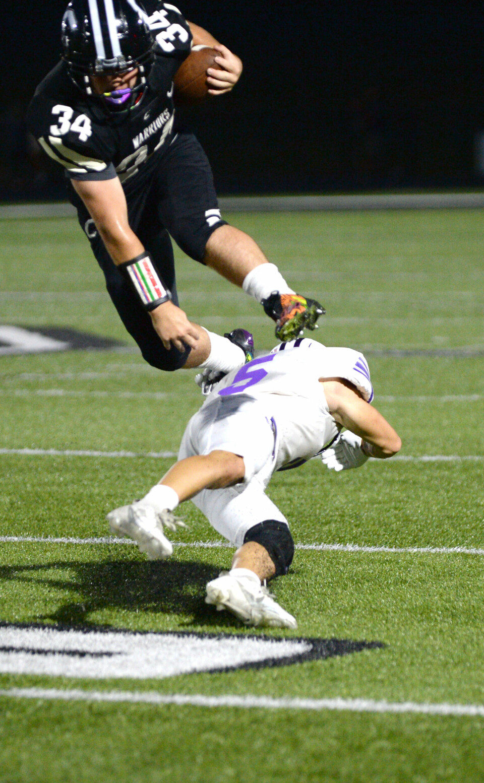 Carrollton senior Levi Crider leaps over a Triway defender in the first quarter.