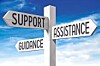 Wooden directional signpost with arrows labeled support, assistance and guidance.