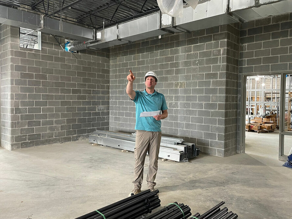 CCM/Carol McIntire Brian Malinsky, project manager for Greenspace Construction Services, points out windows on the east side of the elementary school building that provide a view of Community Field.