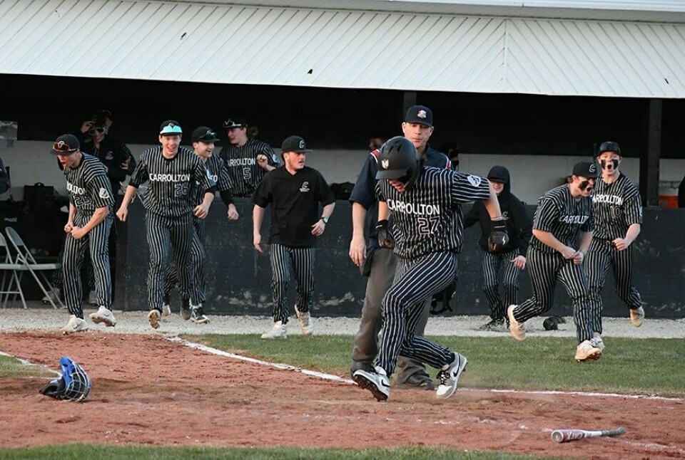 CCM/Dan RiesTeammates celebrate as Cooper Haun steps on home plate for the winning run against Garaway.