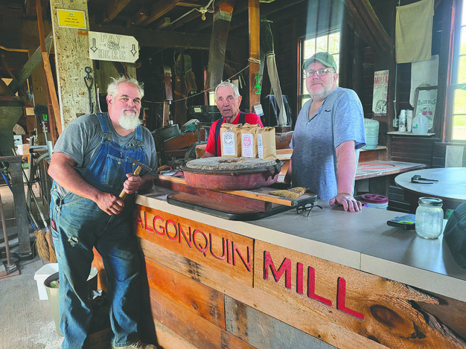 CCM/Connie JenkinsAlgonquin Mill volunteers Vinny Lunemann of Scio, Mel Young of Bolivar and Michael Kaminski of Canton display flour products available for purchase at the facility.
