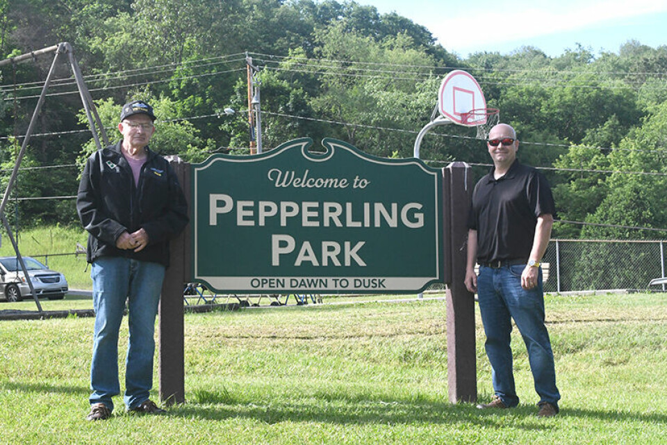 CCM/Carol McIntireFormer Amsterdam Mayor Gary Pepperling (left) and Mayor Jim Phillips, who conducted the dedication ceremony, are shown with the new sign at Pepperling Park.