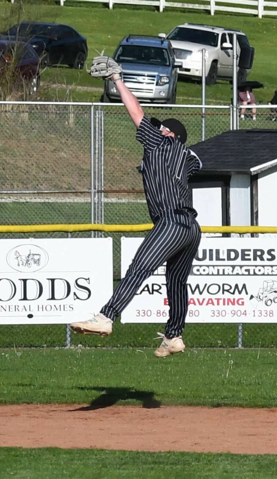 CCM/Dan RiesCarrollton shortstop Isiah McConnell perfectly times his jump for the third out to end a Marlington rally.
