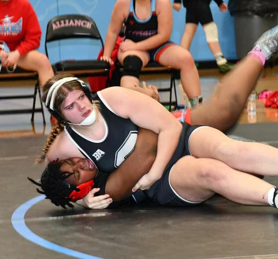 CCM/Carol McIntireWarrior Riley Alborn (black singlet) pinned Alliance’s Chacara Tackett in the first period of the 235-pound girls match.