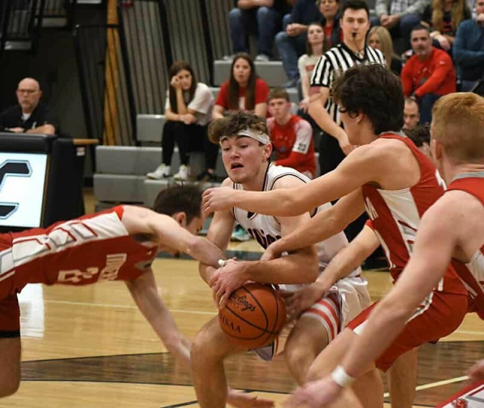 CCM / Dan RiesCarrollton senior Lincoln Mallarnee battles Braydon Wood (24) (left) and Garrett Gonzalez (right) during an IVC battle Feb. 9 in the CHS gym.