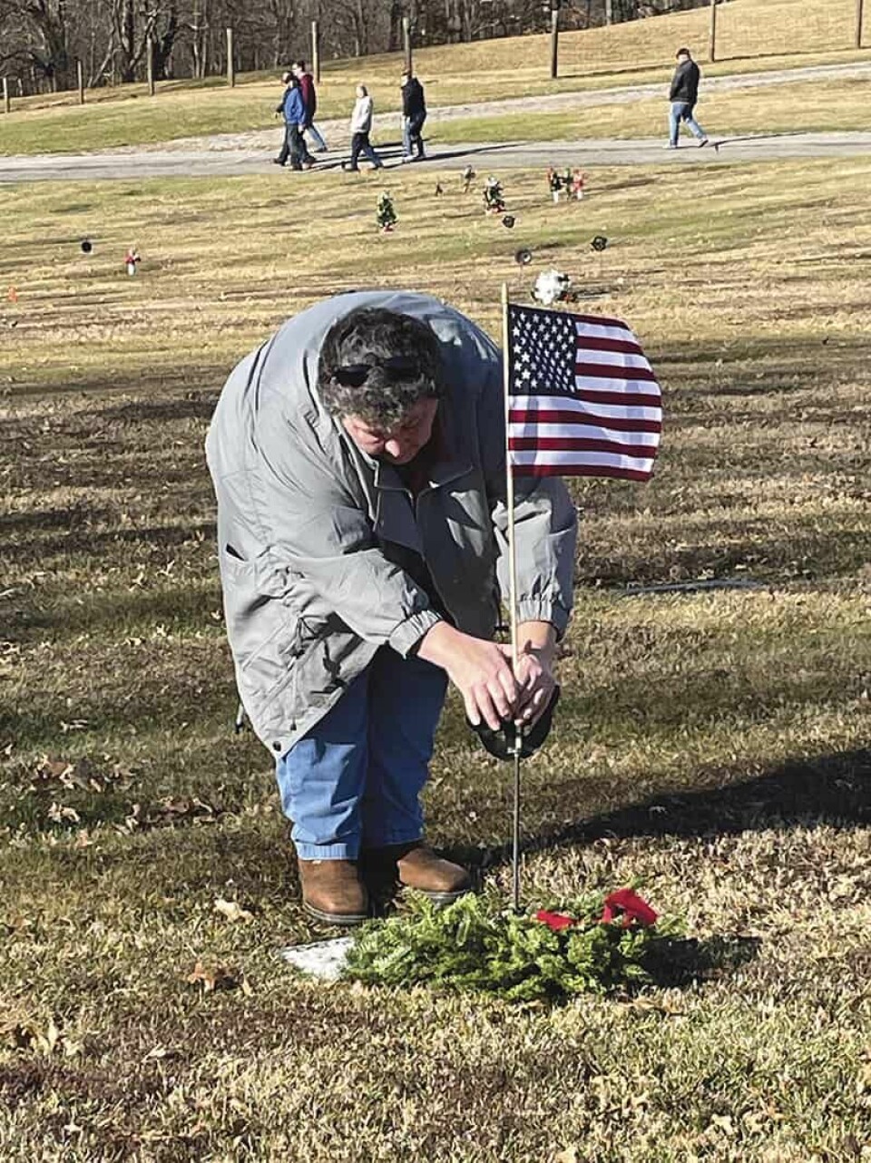 CCM/Carol McIntireShannon Davis places a fresh pine wreath on the grave of Allister D. Miller as part of the Wreaths Across America ceremomy. Miller, who served in the army during World War II, died Sept. 19, 1947.