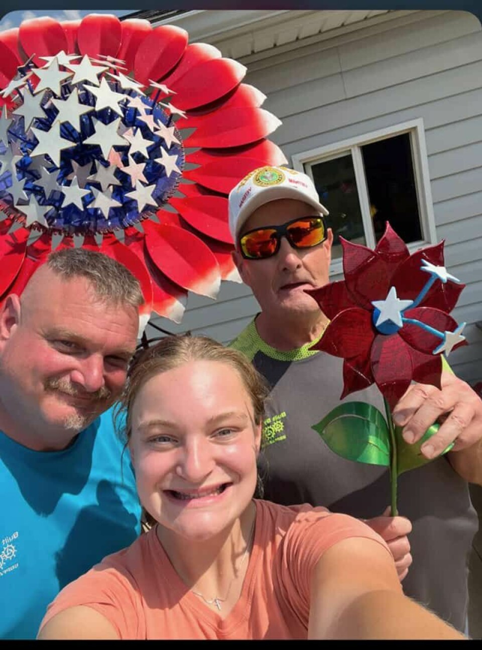Submitted PhotoAaron “Pottsy” Potts is joined by his daughter Elizabeth “Byrd” Potts and his father Bill Potts along with metal flowers for sale.