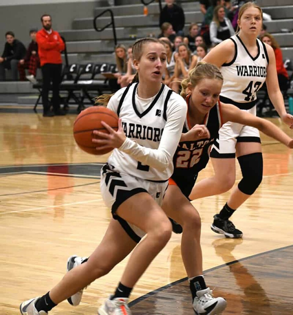 CCM/Dan RiesHillari Baker (2) drives to the basket against Kendall Maibach (22) of Dalton during a non-league game Dec. 23 at Carrollton. Warrior Maleyna Havens (43) follows the action. Baker scored a game-high 22 points in the 67-41 win.