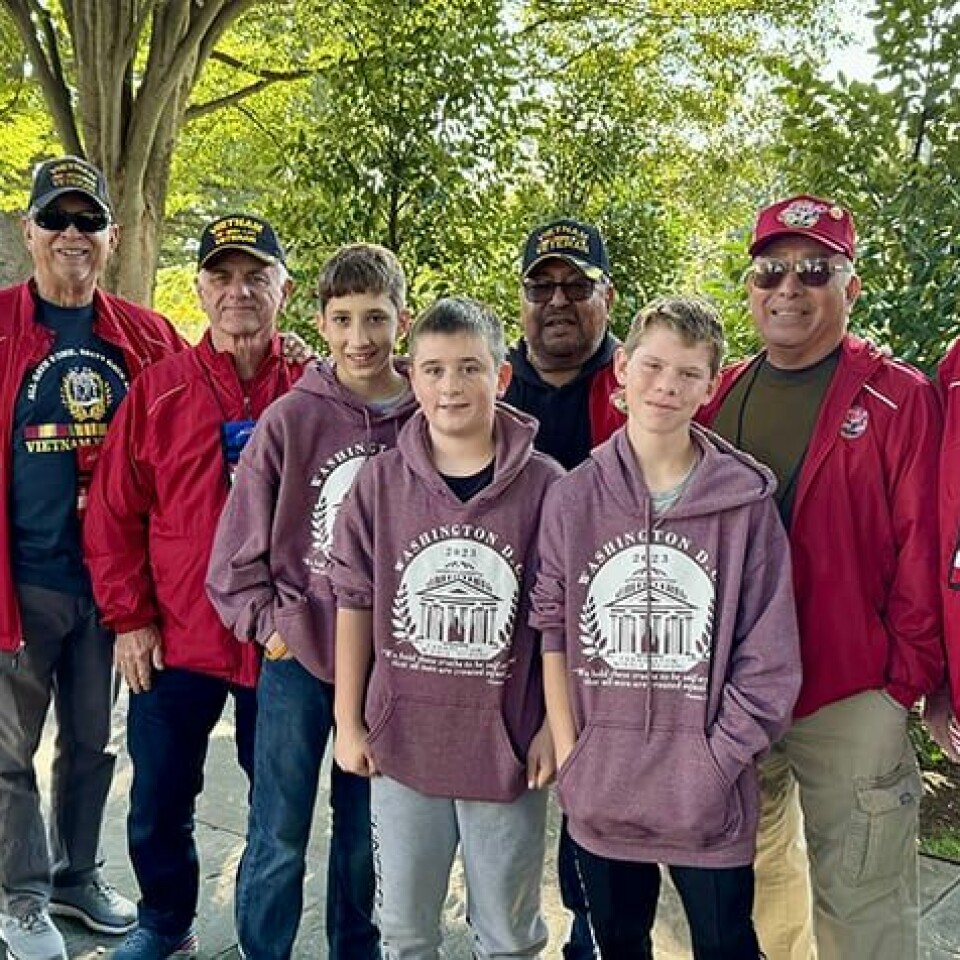 Submitted PhotoCarrollton Middle School students Joseph Miller, Tripp Tetoff and Kasen Farnsworth are shown with several California veterans who were visting Arlington National Cemetery as part of an Honor Flight.