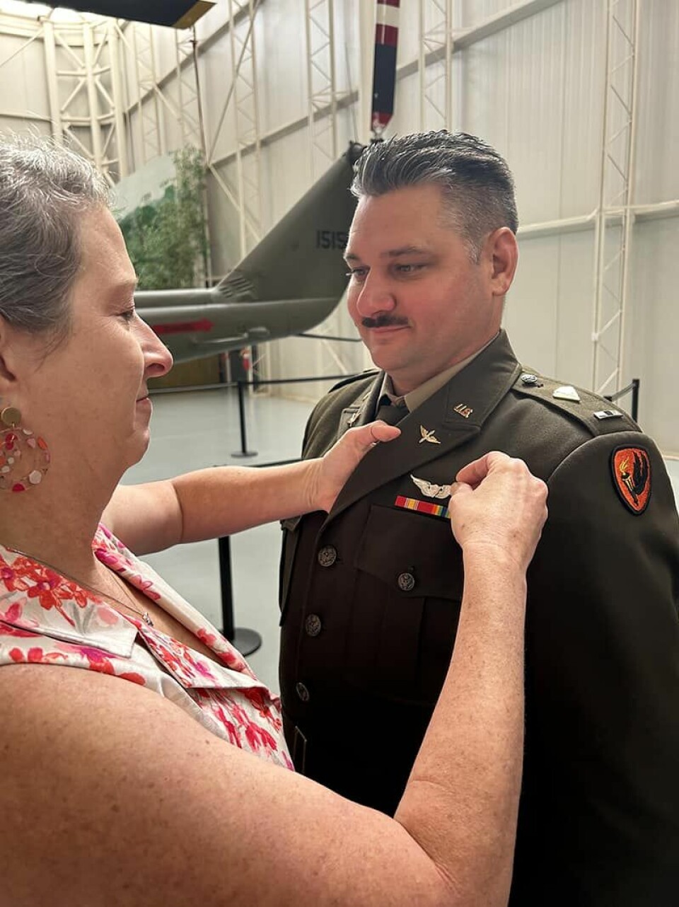 Submitted Photo Rebecca O’Brien pins an Aviator Wing on her husband, Andrew, during a Nov. 2 ceremony at the Army Aviation Museum at Fort Novosel.
