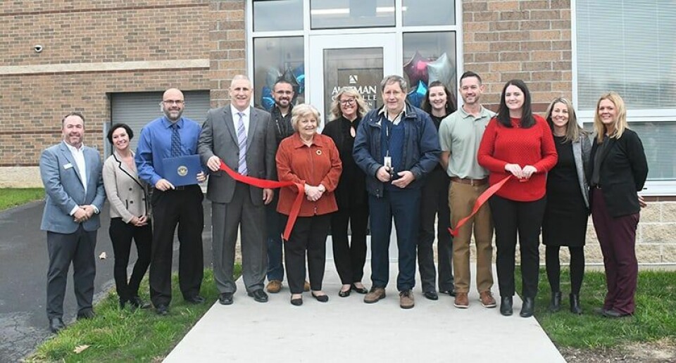 CCM/Carol McIntireRibbon cutting at the Aultman Orrville Carrollton Schools Health Center at the Carrollton High School/ Middle School complex. Those participating in the ribbon cutting are shown above. From left are:Eric Belden, vice president Development, Aultman Foundaitn: Amy Spears, Carrollton Schools Treasurer; Andy Reeves, assistant principal; Dave Davis, superintendent; Rose Seck, school board member, Dan Ries, school board president; Dr.Carl Fry, Sarah Ensinger, APRN, CNP Aultman Orrville Carrollton; Michelle Antulis, executive director of Rural Health Clinics, Aultman Orrville; and Laurel Lucas, RN, Aultman Orrville Carrollton. Standing behind: Jonathan Naylor and Wendy Gotschall, school board members; and Jamie Lewis, senior practice manager, Aultman Orrville Carrollton.