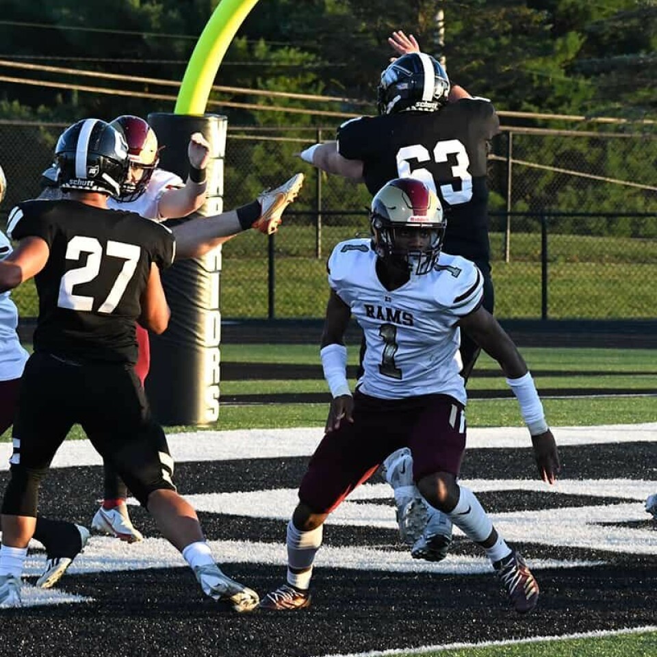 CCM/ Dan RiesCarrollton senior Preston Jackson (63) slips past defender Jason Morris (1) to put pressure on the Garfield punter deep in the end zone Friday. Warrior Carter Matoszkia (27) closes in on the action at left.