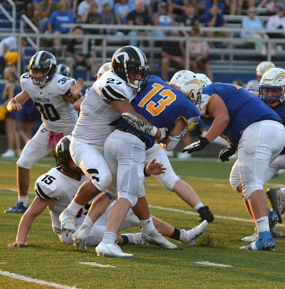 CCM/Pete McIntireCarrollton receiver Landon James drags a defender as he heads upfield after catching a pass against Philo. Defender Talan Bailey is closing in on the action.