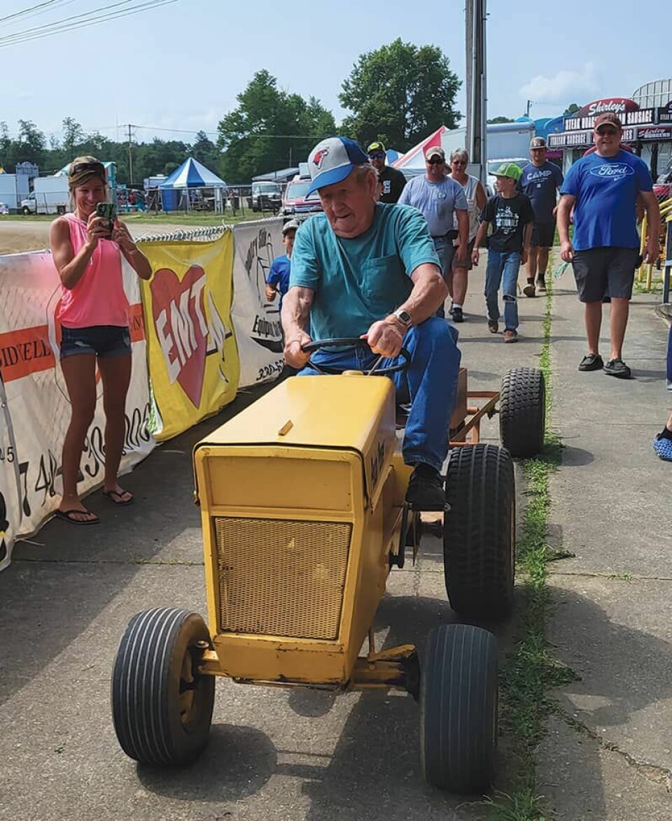 A determined John Beadnell participates in the pedal tractor pull at the Carroll County Fair. Beadnell had a distance of 81-feet, 2-inches.