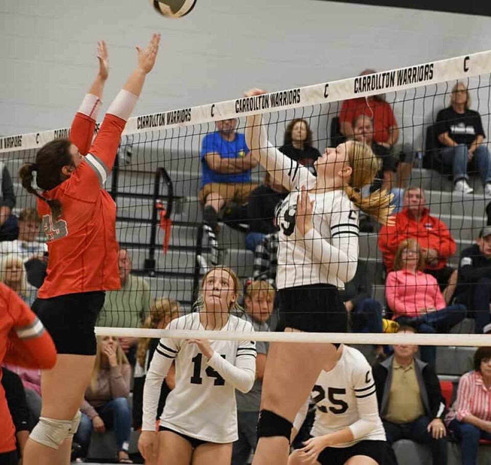 CCM/Dan RiesMinerva’s Sierra Cress (red) goes up for a block against Carrollton’s Maleyna Havens(19). Emma Shafer (14) watches the action.