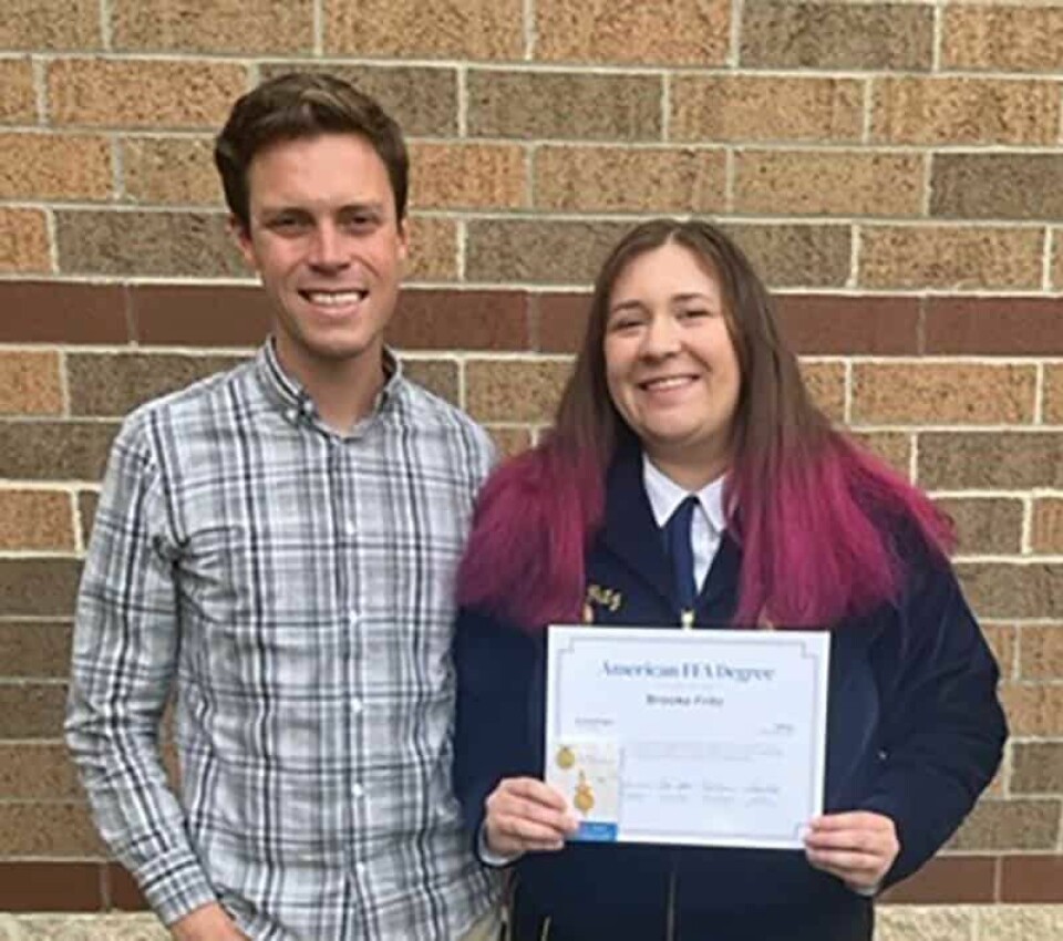 Submitted Photo: Brooke Fritz (right) is joined by Carrollton FFA Advisor Ryan Borland. Fritz earned her American FFA degree.