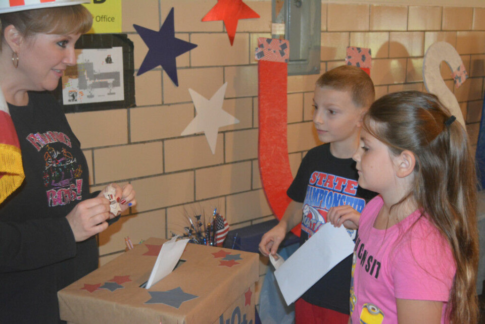 Elementary students participate in mock election Tiffany Haines (far left) is pictured helping second graders at Keene Elementary School cast their ballot in the school’s mock election that was held Nov. 8. Josie Sellers | Beacon