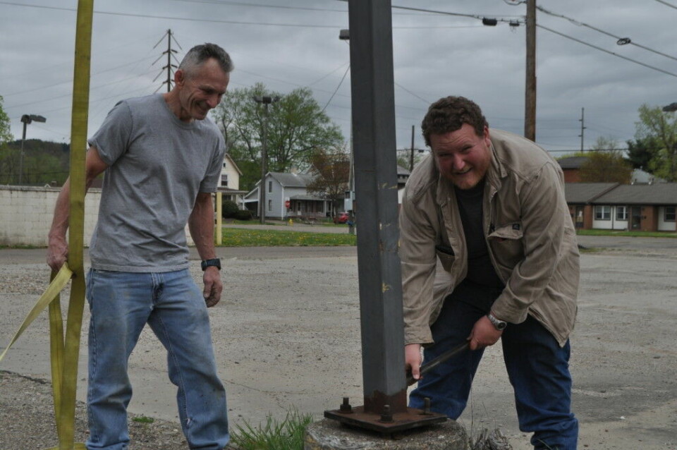 Bank donates light poles to Indian Mud Run Century National Bank donated the light poles that were on the site of the bank’s additional Coshocton branch which will be located on North Third Street following construction. Pictured are Hubie Cushman, (left) Indian Mud Run organizer and Vic Allen of Allen Construction who donated his time and equipment to remove the light poles. The poles will be used for an obstacle on the Indian Mud Run course. Mark Fortune | Beacon