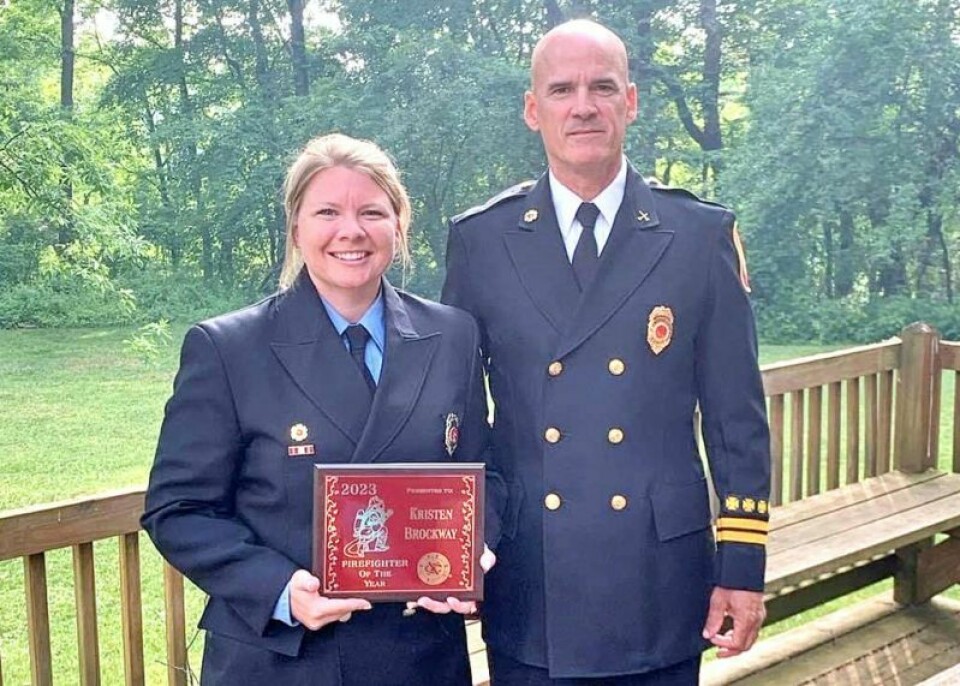 Wooster Division of Fire Firefighter of the Year Kristen Priest-Brockway holds her award, flanked by Division of Fire Capt. Mike Maag. Priest-Brockway has had memorable year with Wooster Fire Dept.