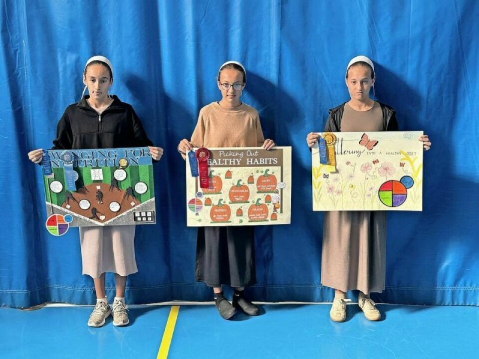 Sarah Miller, left, Kari Yoder and Lyla Yoder showcase their award-winning poster entries in the MyPlate Poster Contest designed to highlight the value of proper nutrition and exercise. MyPlate posters bring out the creative side in students