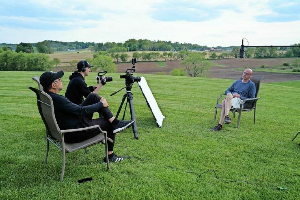“Angel in Amish Country” filmmakers Jay Maximo, left, and Dan Mizicko chat with former Hiland hoops standout and Hiland High School Athletic Director Art Yoder as part of their filming of the documentary featuring Perry Reese Jr. Reese documentary website preps project for final push