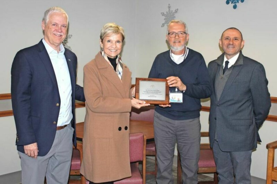 Rick Haines, president and CEO of Aultman Health Foundation, left, and Vicki Haines present the Vicki Haines Legacy Award to Joel Chupp and Brian Reilly of the Viola Startzman Clinic. Viola Startzman Clinic wins legacy award