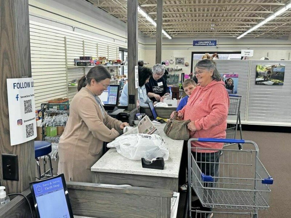 Katrina Schneiter, a Young Life committee member, bags another sale at Save & Serve. Both nonprofits teamed up for a day of work that served a purpose for both parties. Save & Serve unites with Young Life for a day