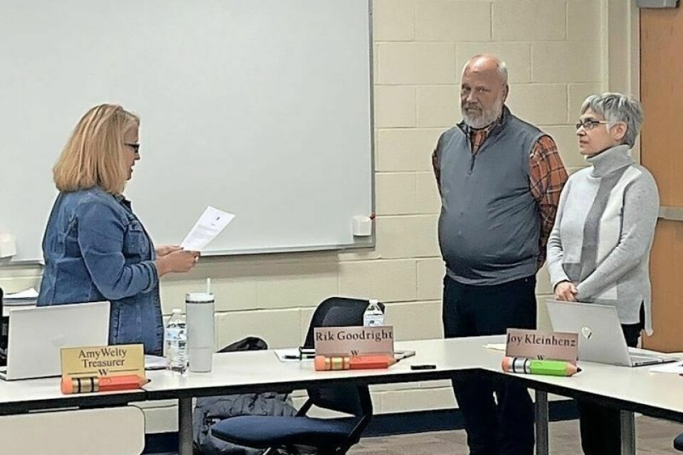 Wooster City Schools treasurer Amy Welty, left, swears in the newest members of the WCS Board of Education: Rik Goodright and Joy Kleinhenz. New members join WCS school board