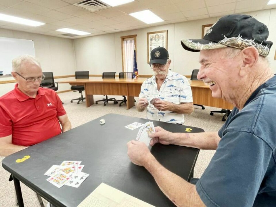 Randy Levengood, left, Bill Wasem and Don Vrsan show how the game is played. A fourth member could not make it to the interview, but the hand he would have been dealt is shown face up. Bolivar Jass club to celebrate 90th anniversary