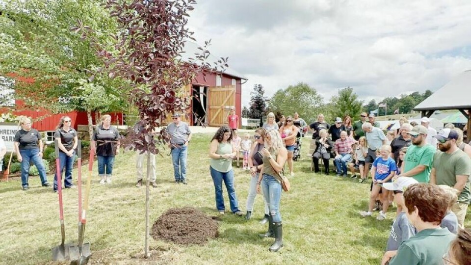 Dave and Diane Martins’ daughters Kendra, left, Kayla and Keisha were gracious to the large crowd of people who turned out to honor the memory of their parents during a tree-planting ceremony at Harvest Ridge on Monday, Aug. 7. Fair board honors Martins in emotional ceremony