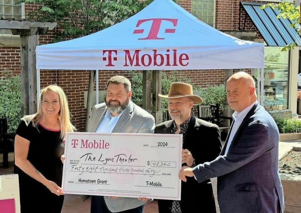 Dana Edwards, left, of T-Mobile presents a Hometown Grant check for $48,340 to Lyric Theater Managing Director Jeremy Thomas, Lyric Board President Greg Shaya and Wooster Mayor Bob Reynolds in a presentation held Sept. 12 in downtown Wooster. Lyric Theater gets grant from T-Mobile program