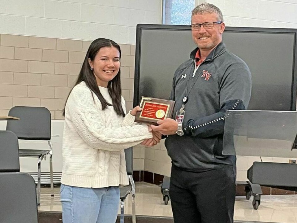 Addelina Carroll, left, athlete of the month, played golf, and High School Principal Jason Philips presents a plaque. Tusky Valley district exceeds state standards