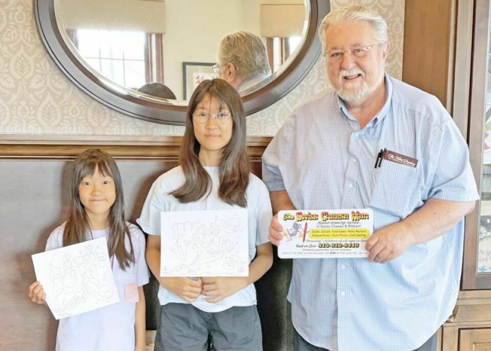 If you’ve been around Holmes County long enough, you’ve probably run into Philip Sarlo, right, at various events where he is inevitably set up with a crowd of kids around him. The speed drawer tirelessly draws names in firm, blocky letters to the delight of children of all ages. ‘Swiss Cheese Man’ draws to the delight of children
