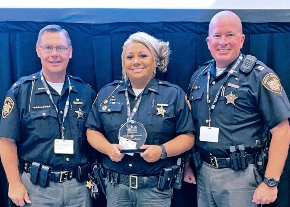 Wayne County Sheriff Travis Hutchinson, left, and Capt. Ryan Koster, right, pose with SRO Jodi Kauffman. Kauffman recently received the Stand Out Award from Gov. Mike DeWine for her ongoing dedication to the Triway School District. SRO Kauffman receives state award from Gov. DeWine