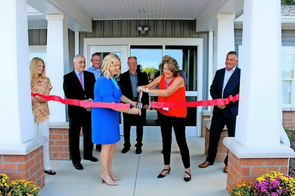 Natalie Bollon, left, of the ADAMHS board and Pam Trimmer of OhioGuidestone cut the ribbon at a ceremony for the new facility. Men’s residential treatment center to open in Dennison