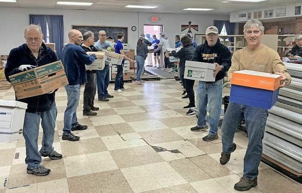 Volunteers move boxes of books used for the annual AAUW/Kiwanis Used Book Sale. The clubs recently moved their book drop-off site to the red barn behind Zion Lutheran Church on North Market Street in Wooster. AAUW/Kiwanis book drop is moved to new location