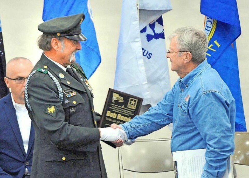 Vietnam-era veteran Jeff Sampsel, left, presented Bob Romig with the 2023 Veteran of the Year during the Veterans Day service at the Wayne County Fairgrounds Event Center on Nov. 11. Veterans Day service concludes with highway dedication