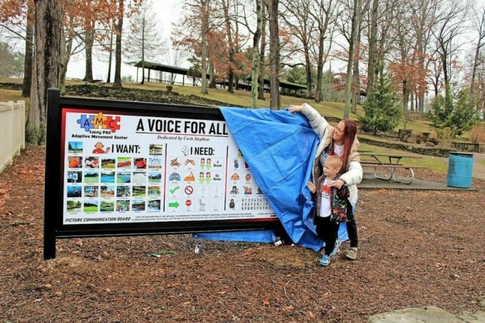 Lacey Herbert-Stephen and her son Cash Stephen unveil a new communication board at Tuscora Park. Communication boards installed at Tuscora Park