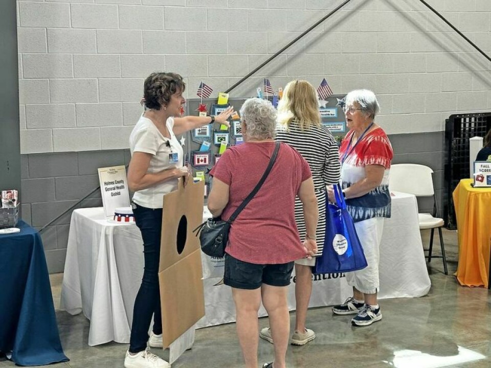 Kerry MacQueen, Holmes County General Health District, visits with a group of seniors during the Holmes County Fair Senior Citizen Day activities. Elder statesmen have a ball at fair’s Senior Citizen Day