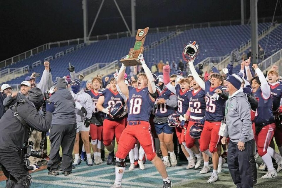Senior Jaxon Burcher holds the state title trophy aloft. Indian Valley victorious in first football state championship game