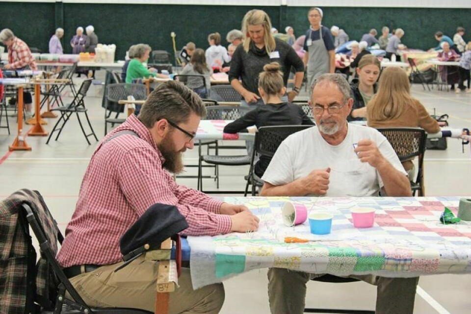 Caleb Pearce, left, and Ken Neuenschwander work together to knot a comforter at the 2023 Ohio MCC Comforter Bash. Throughout two days on March 8-9, volunteers will gather at Fairlawn Mennonite Church for the 2024 event knotting comforters for MCC. Fairlawn Mennonite hosting Ohio MCC Comforter Bash