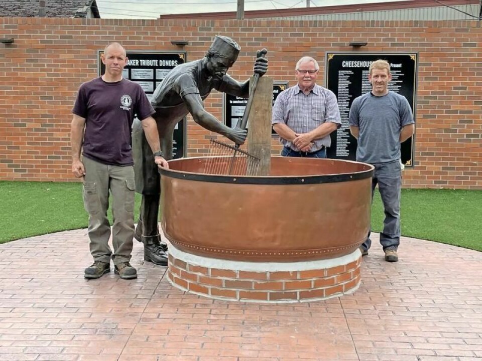 Josh Becker, left, Mayor Walt Wilson and Brent Cottrill stand at the finished product. Cheesemaker Sculpture is in place
