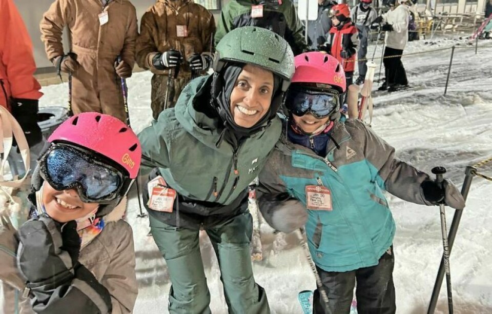 Seresha Clark and two of her daughters smile while waiting to board the ski lift at Snow Trails as part of the Dalton Ski Club. Dalton students hit the slopes, have fun in Ski Club