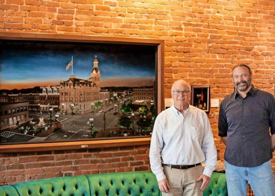 Wooster Mayor Bob Breneman, left, and artist Michael Jackson stand in front of Jackson's painting of downtown Wooster at dusk, commissioned by local attorney Jeffrey Musselman. It is currently on display at Grigio Wine & Cocktail Bar as part of Jackson’s current art exhibit. Jackson painting donated to City of Wooster