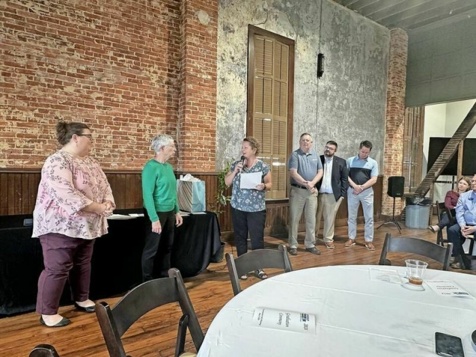 Earlier this summer Holmes County Education Community Foundation Executive Director Shasta Mast, with microphone, and Tiffany Gerber, executive director of the Holmes County Chamber of Commerce, announced a new Holmes County leadership scholarship in honor of Leah Miller, in green. HCECF introduces Leah Miller scholarship
