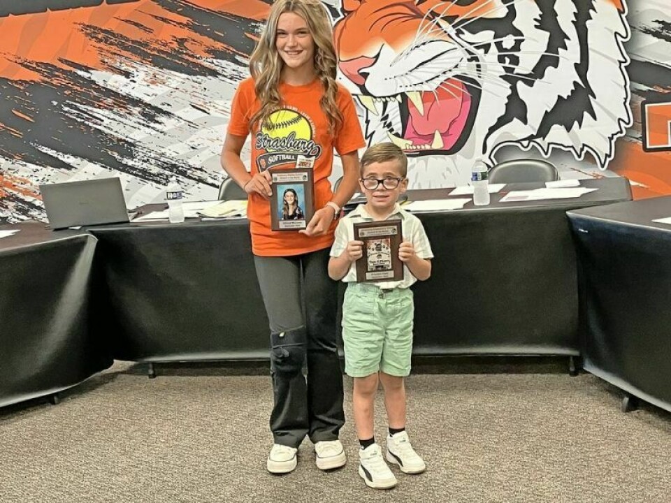 Adrena McComb, middle school, left, and Prestyn Yant, elementary, received a plaque donated by the Lions Club and the district. Strasburg BOE discusses report card for the district