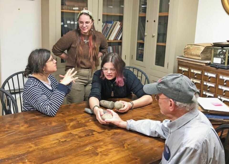 College of Wooster professor Olivia Navarro-Farr, left, archaeology majors Auna Campbell and Des Smith, and Roger Rowe from the Wayne County Historical Society examine artifacts from the society’s collection including two pestles from the Archaic Period, approximately 7500-1000 B.C. Archaeology Day at WCHS to offer fun and education